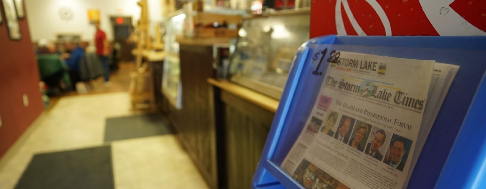 Storm Lake Times newspaper in blue plastic box in a diner